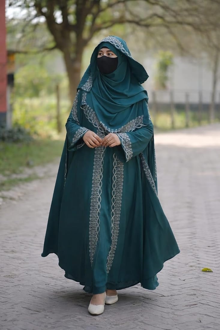 Woman in a teal embroidered Persian robe and veil
