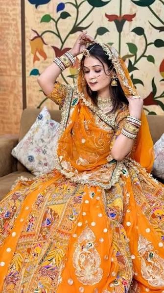 Woman in a saffron Rajputi poshak with traditional jewellery